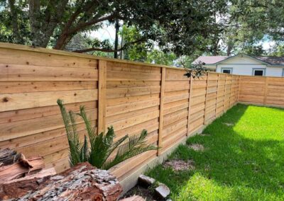 Horizontal cedar privacy fence in a backyard
